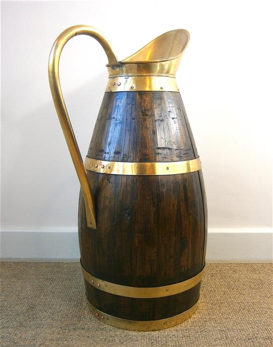 An oak and brass jug stick stand height 66cm